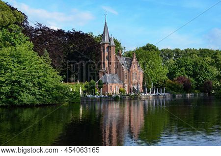 Bruges, Belgium - June 14, 2019: De La Faille Castle With Beautiful Garden On Minnewater Lake
