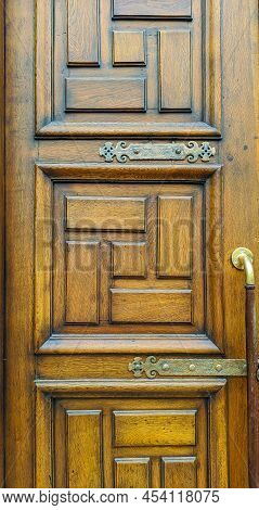 Wooden Door In Brown Color With A Pattern Of Squares And Rectangles On The Right Combined Wood And M