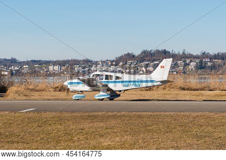 Wangen-lachen, Switzerland, February 13, 2022 Piper Pa-28-161 Warrior Ii Is Taxiing On A Small Airfi