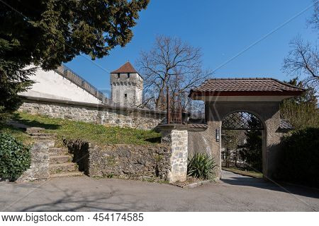 Lucerne, Switzerland, March 10, 2022 Historic Old Tower In A Pretty Park At The Musegg Walls On A Su