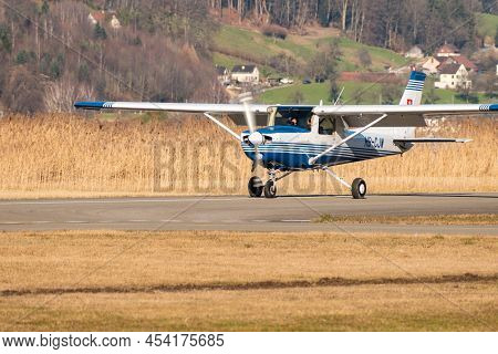 Wangen-lachen, Switzerland, February 27, 2022 Cessna 152 Propeller Plane Is Taxiing On A Small Airfi