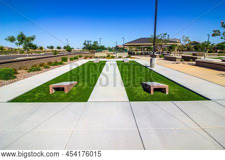 Two Corn Hole Courts With Artificial Grass In Public Park