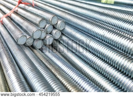 Selective Focus Of Many Long Screw Threaded Rods In Construction And Industrial Concept