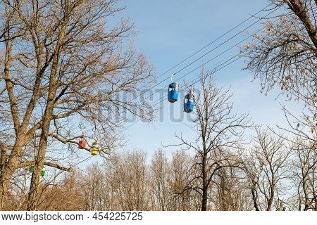 Beautiful Cabins Of Chairlift On Autumn Pine Forest Background
