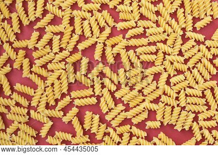 Dry, Undercooked, Colored Pasta On A Bright, Light, Even Canvas.