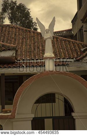 Cuenca, Ecuador, 29 June 2019. Sculpture Of An Angel On A House Next To The Church Of Turi In Cuenca