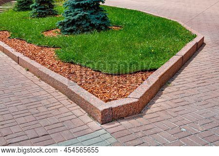 Pine Mulch On The Garden Bed On Park. City Scape Landscape Design With Wooden Chips On Flower Bed Wi