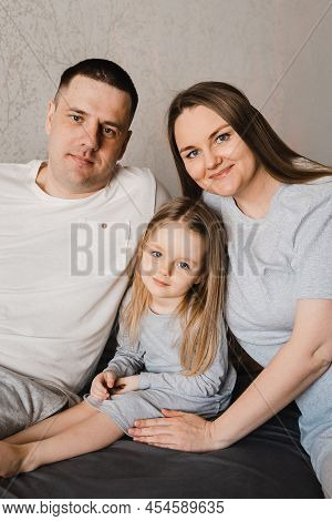 Portrait Of Loving Family With Infant Daughter. Happy Caucasian Family Of Three People. Selective Fo