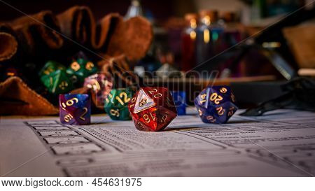 Close Up Of Spilling Out Dice Of Different Kinds From A Dice Bag On A Character Sheet.