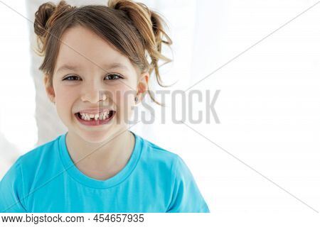The Kid Lost A Tooth. Baby Without A Tooth. Portrait Of A Little Girl No Tooth. High Quality Photo