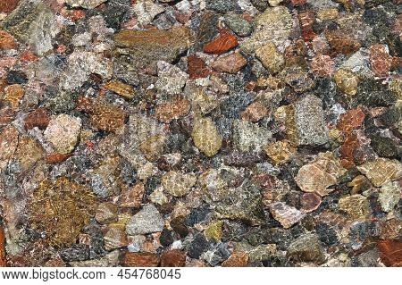 Top View Of Colorful Sea Stones Under The Water. Transparent Sea Water With Reflections