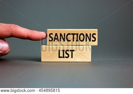 Sanctions List Symbol. Wooden Blocks With Concept Words Sanctions List On Beautiful Grey Background.