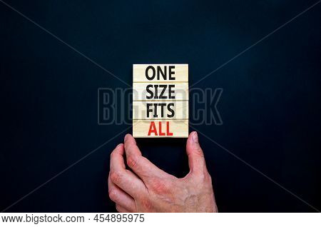 One Size Fits All Symbol. Concept Words One Size Fits All On Wooden Blocks. Businessman Hand. Beauti