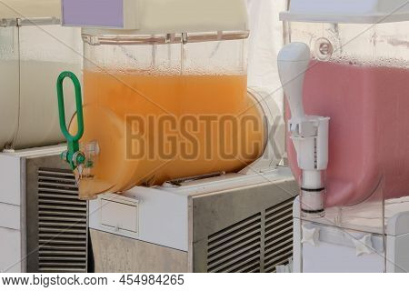 Dispenser With Cold Black Cherry Flavored Grenadine Or Orange For Sale  In The Drinks Kiosk On The B