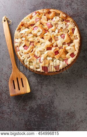 Delicious Homemade Rhubarb Pie With Almonds Close-up In A Dish On The Table. Vertical Top View From 