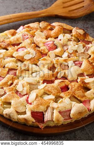 Swedish Rhubarb Cake Rabarberkaka With Almond Flakes Closeup In The Plate On The Table. Vertical