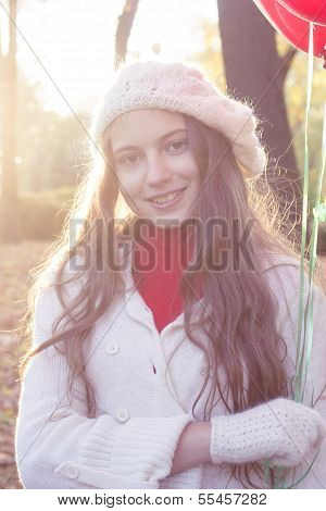 young girl walking in the autumn park
