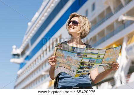 Woman with map, in front of cruise liner