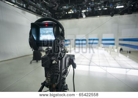 Television studio with jib camera and lights - camera on a crane. Shallow depth of field - focus on camera 