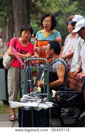 Beijing, China - Jul 17, 2011: . Women And Men Are Singing In Jingshan Park. It's A Popular Traditio