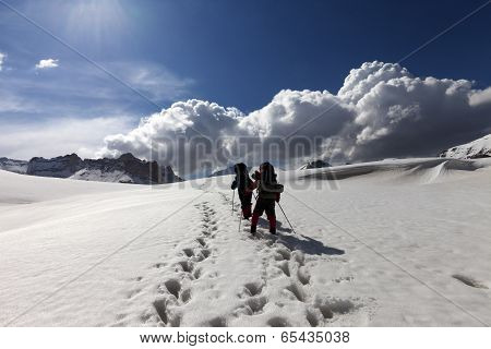 Two Hikers On Snowy Plateau