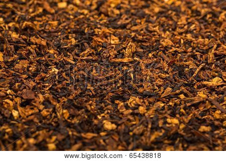 Background is of chopped tobacco leaves.