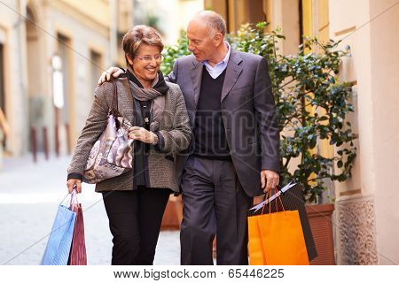 Senior Old Man And Woman Shopping In Italy