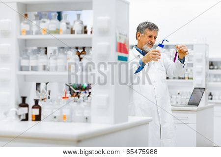Senior male researcher carrying out scientific research in a lab (shallow DOF; color toned image)