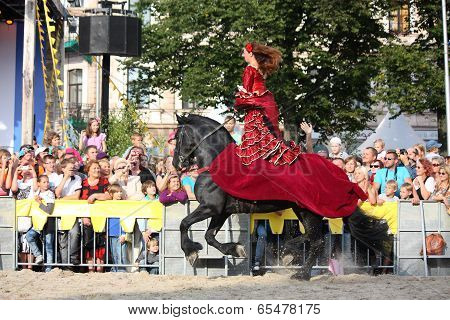 Riga, Latvia - August 21: Camilla Naprous From The Devils Horsemen Stunt Team Riding Beautiful Black