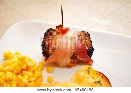 Bacon Wrapped Meatloaf Served On A Plate