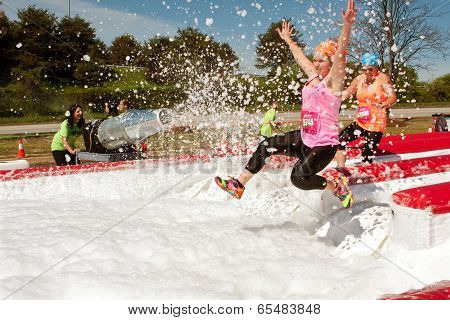 Women Get Sprayed With Bubbles Jumping Into Foam Pit