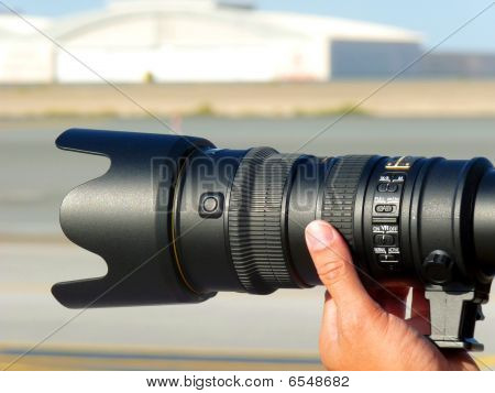 Professional Photographer taking Shot with a Telephone Lens.