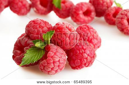 ripe raspberries with mint  isolated on white