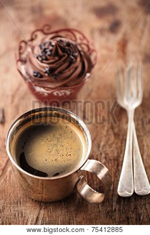 coffee and cupcake in rustic style on wooden table