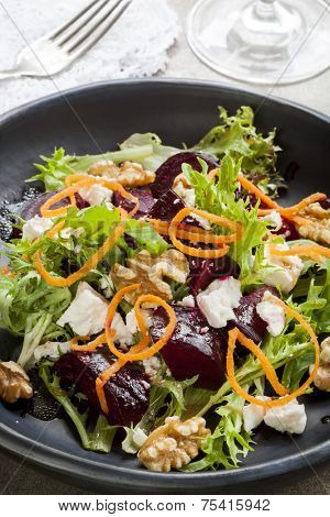 Beetroot salad with feta cheese, walnuts and carrot.