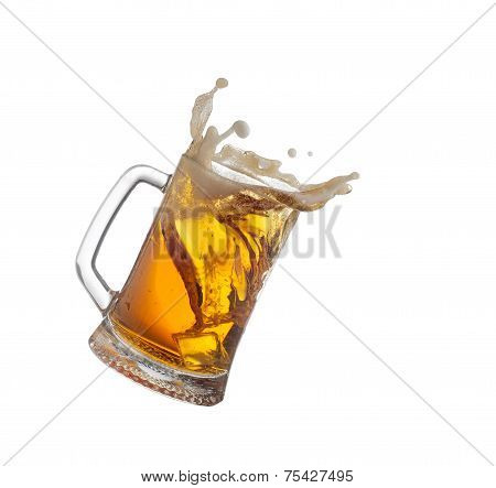 Splashing mug with beer isiolated on white .