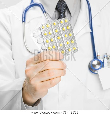 Doctor Holdling Pills In His Hand
