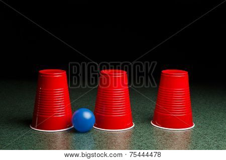 Three Red Cups And A Blue Ball