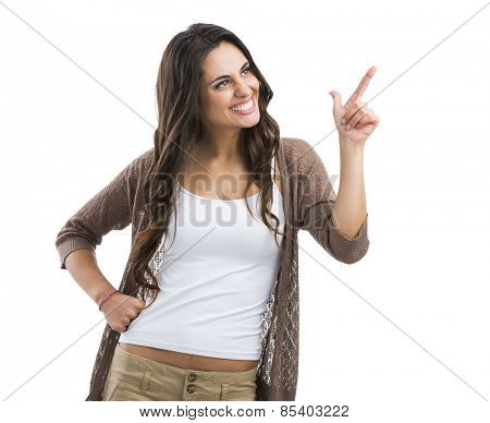 Beautiful brunette woman laughing and pointing to the left, isolated over white background