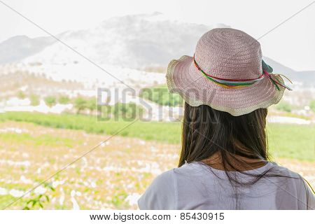 Young Woman In Summer Looking Aimlessly At Vineyard .