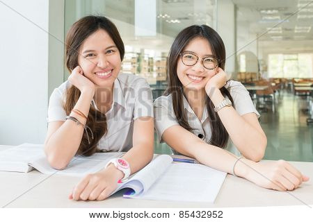 Two Asian Students Studying Together At University