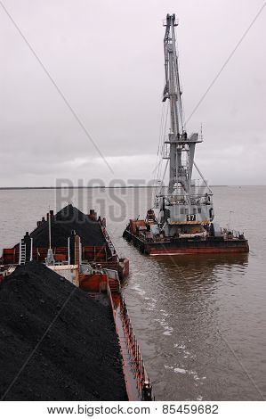 Cargo Crane At Platform Near Ship With Coal