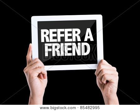 Tablet pc with text Refer a Friend isolated on black background