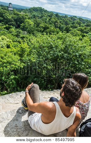 Tourist Taking Photos And Enjoying The View Of Rainforest And Mayan Ruins . Tikal National Park Trav