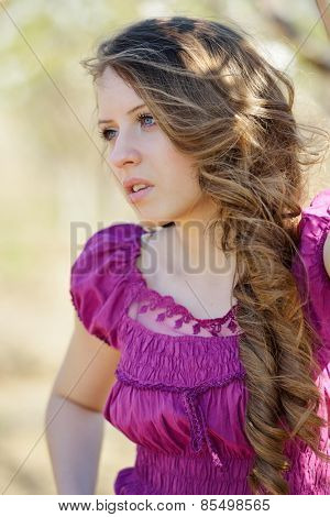 young beautiful woman portrait on field in summer