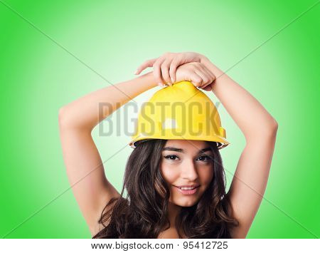 Young woman with hellow hard hat against gradient 