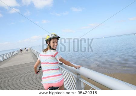 Portrait of young woman riding bike on a pontoon