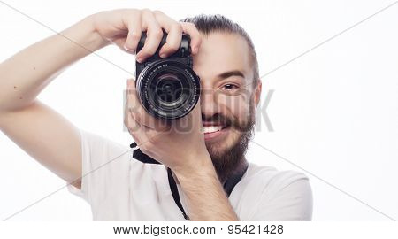 Travel, technology and life style concept: young bearded  photographer taking pictures with digital camera.