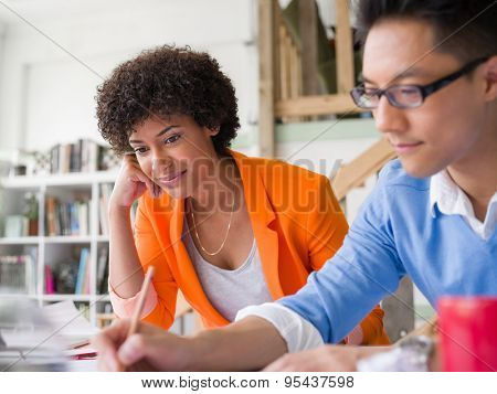 Two desingers working on a project together in office
