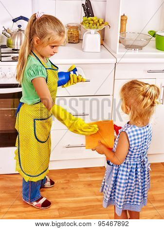 Children sister cleaning  home kitchen. Housekeeping.